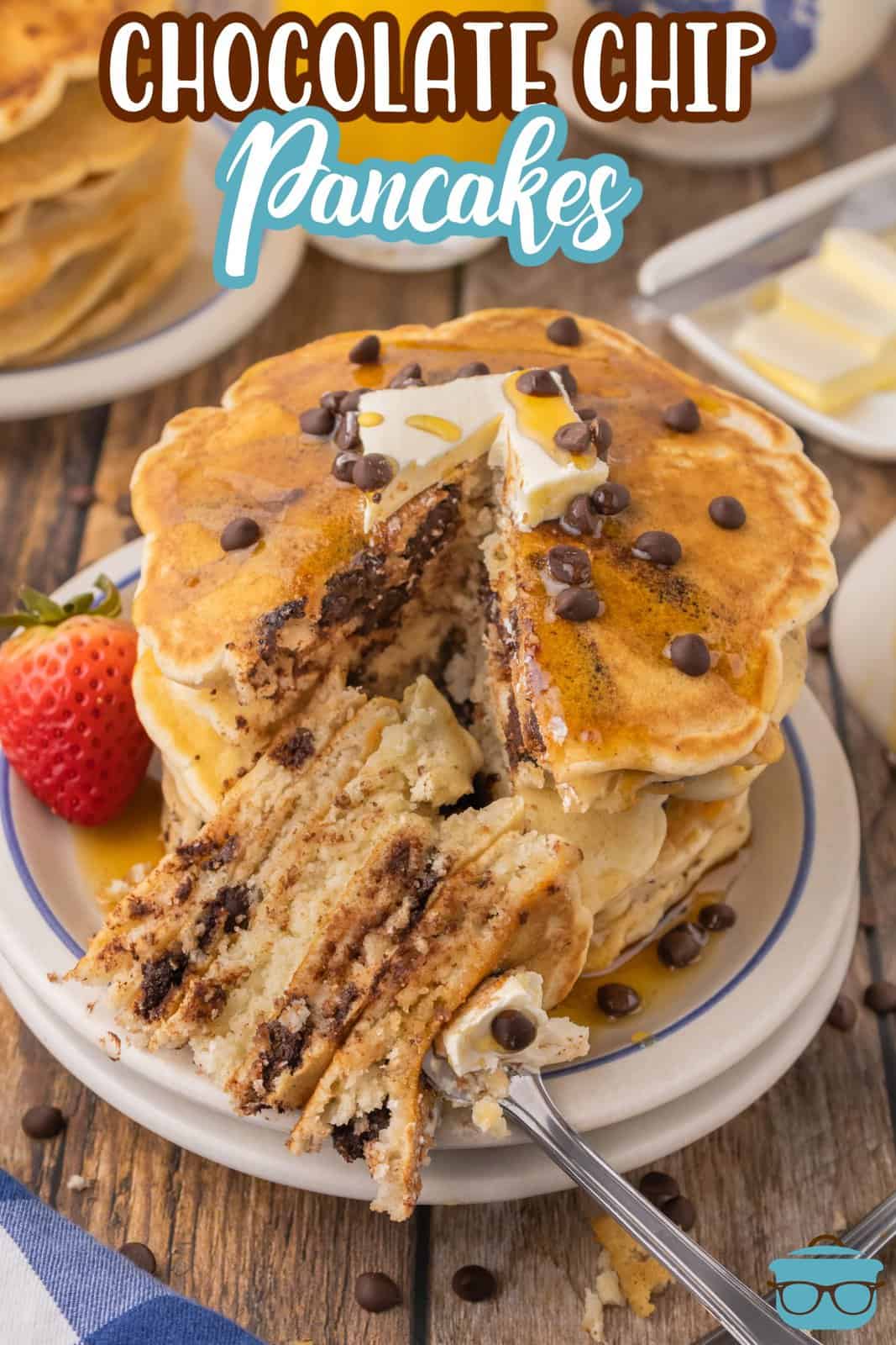 A stack of homemade Chocolate Chip Pancakes with a large slice taken out of the stack. 