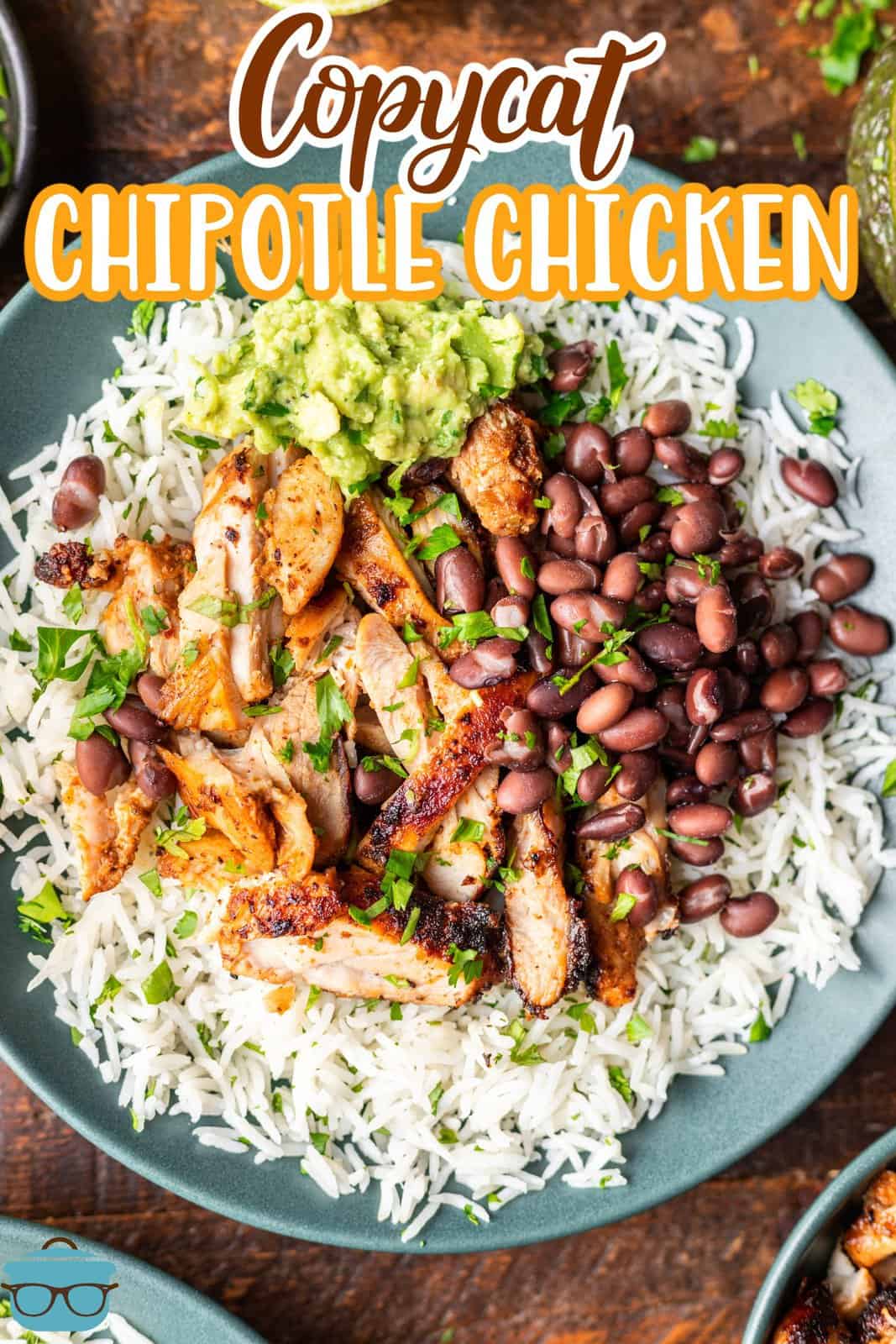 A plate with Chipotle Chicken over a bed of rice with beans. 