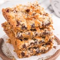 A stack of Magic Cookie Bars on a serving platter.