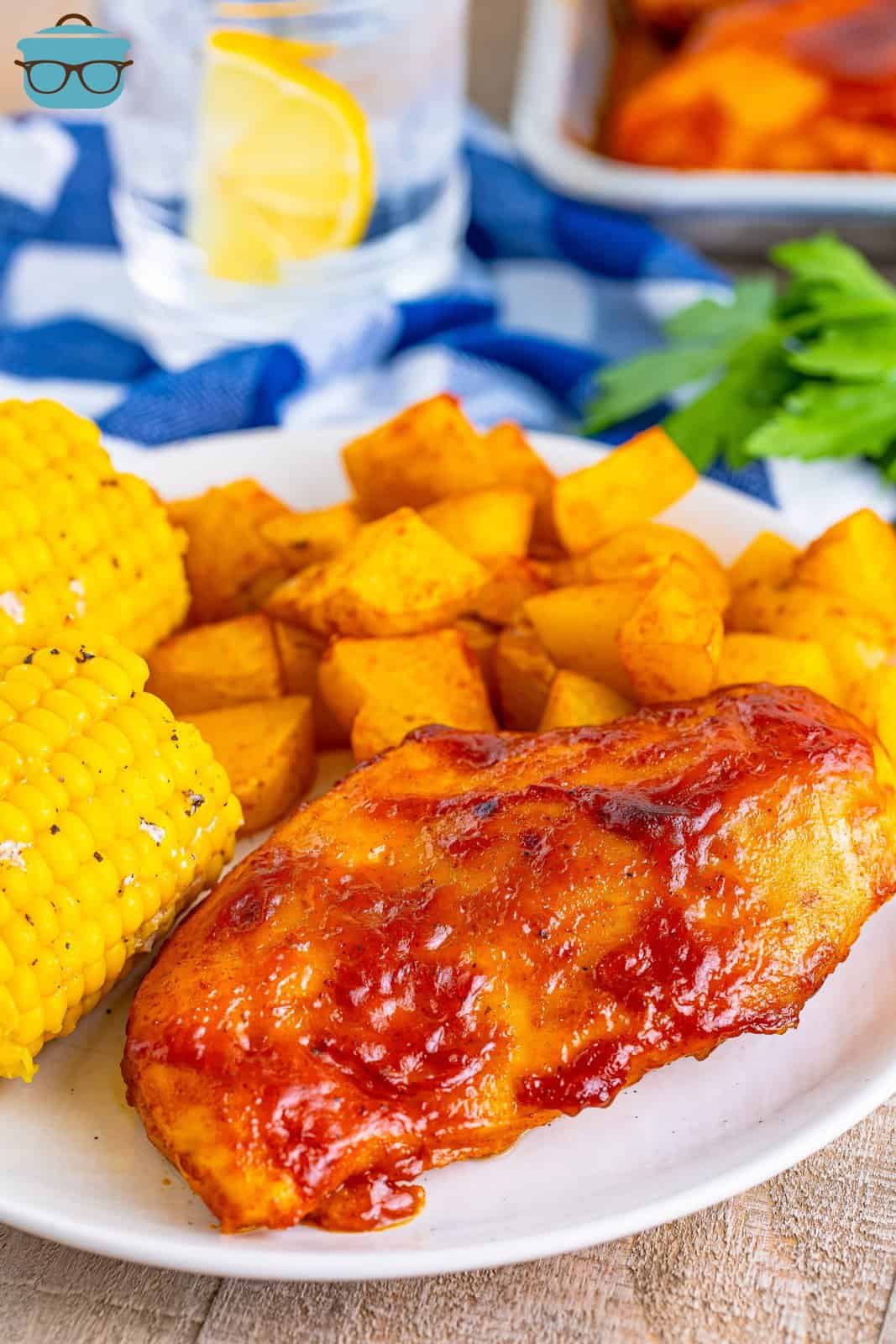 A close look at the plate of chicken, potatoes, and corn.