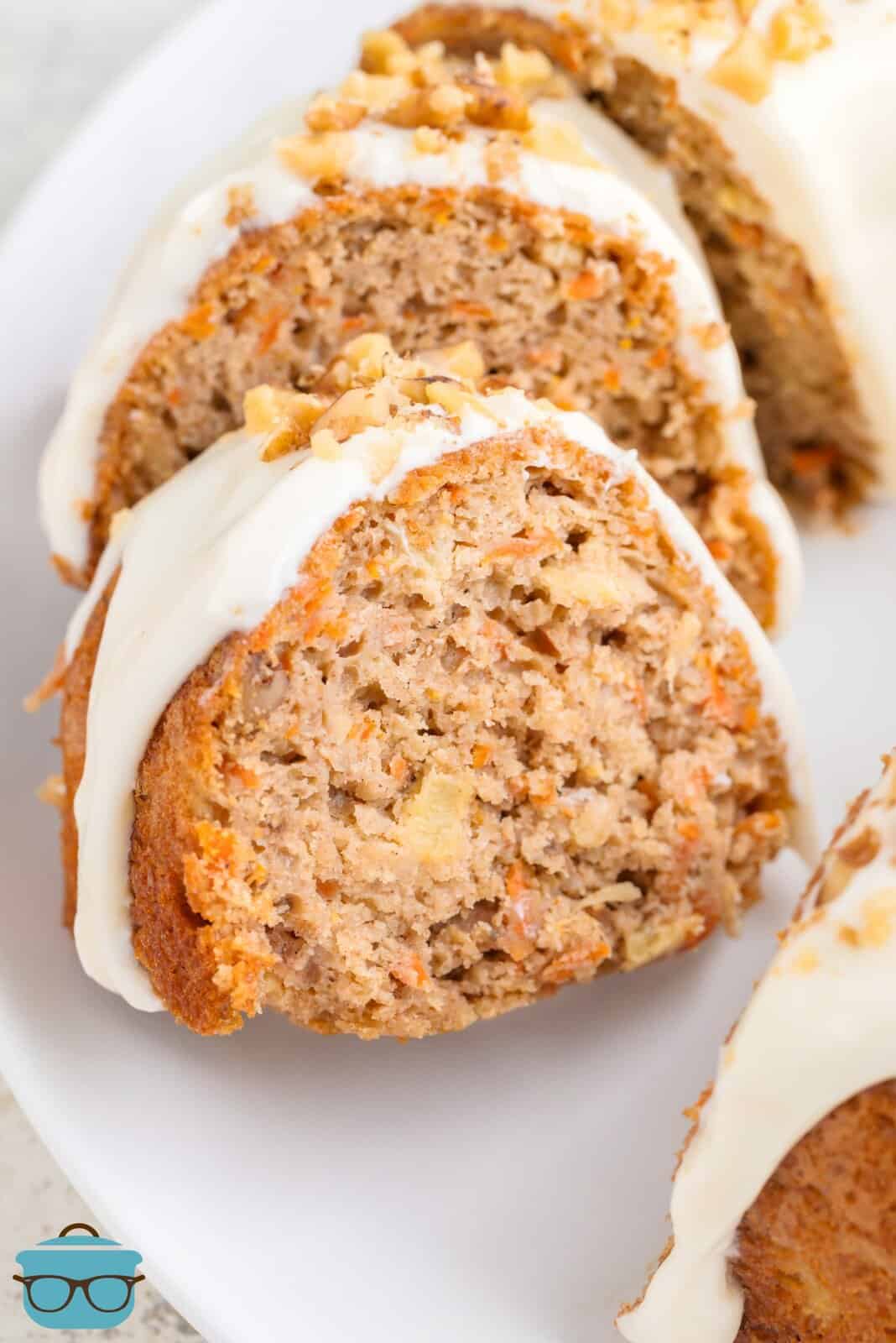 A few slices of Carrot Bundt Cake with glaze and chopped nuts on a serving plate.