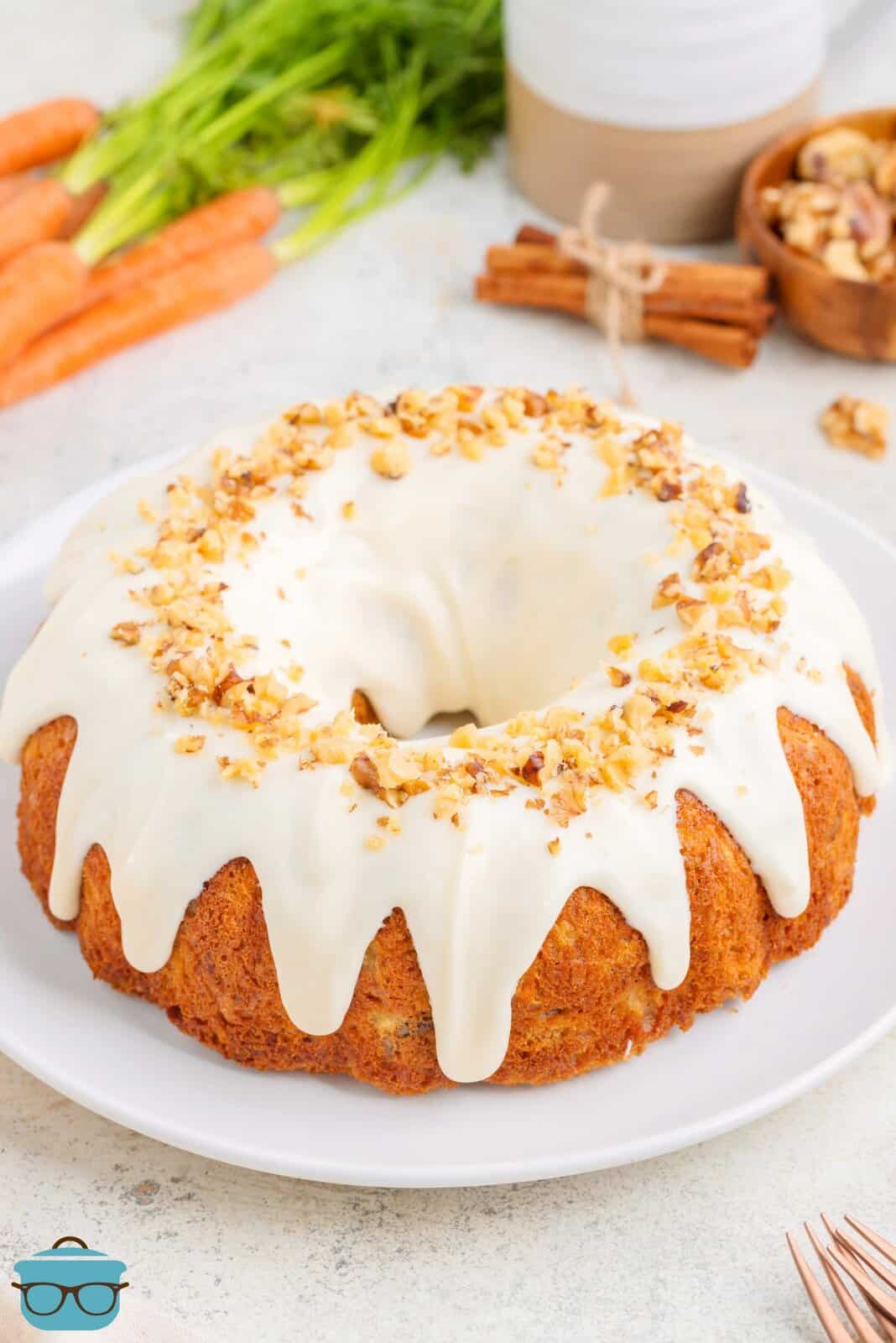A homemade Carrot Bundt Cake with glaze on a serving plate.