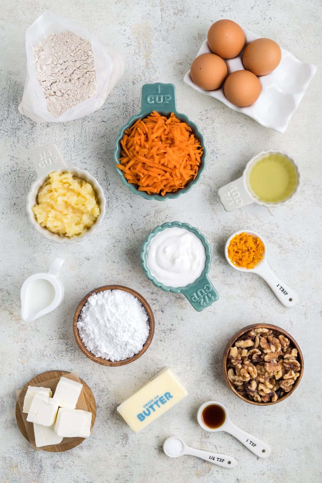 Spice cake mix, shredded carrots,eggs, canola oil, sour cream, cream cheese, orange zest, pineapple, walnuts, unsalted butter, powdered sugar, vanilla extract, kosher salt, and whole milk.