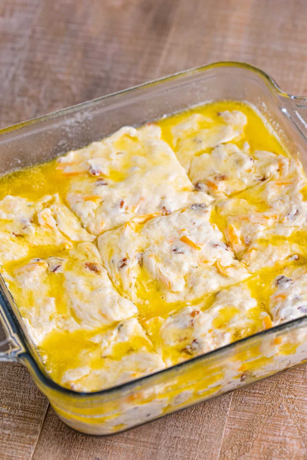 Cut biscuit dough and melted butter in a baking dish.