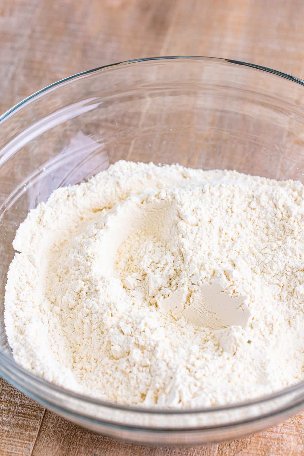 A bowl of flour, sugar, baking powder, and dried ranch seasoning.