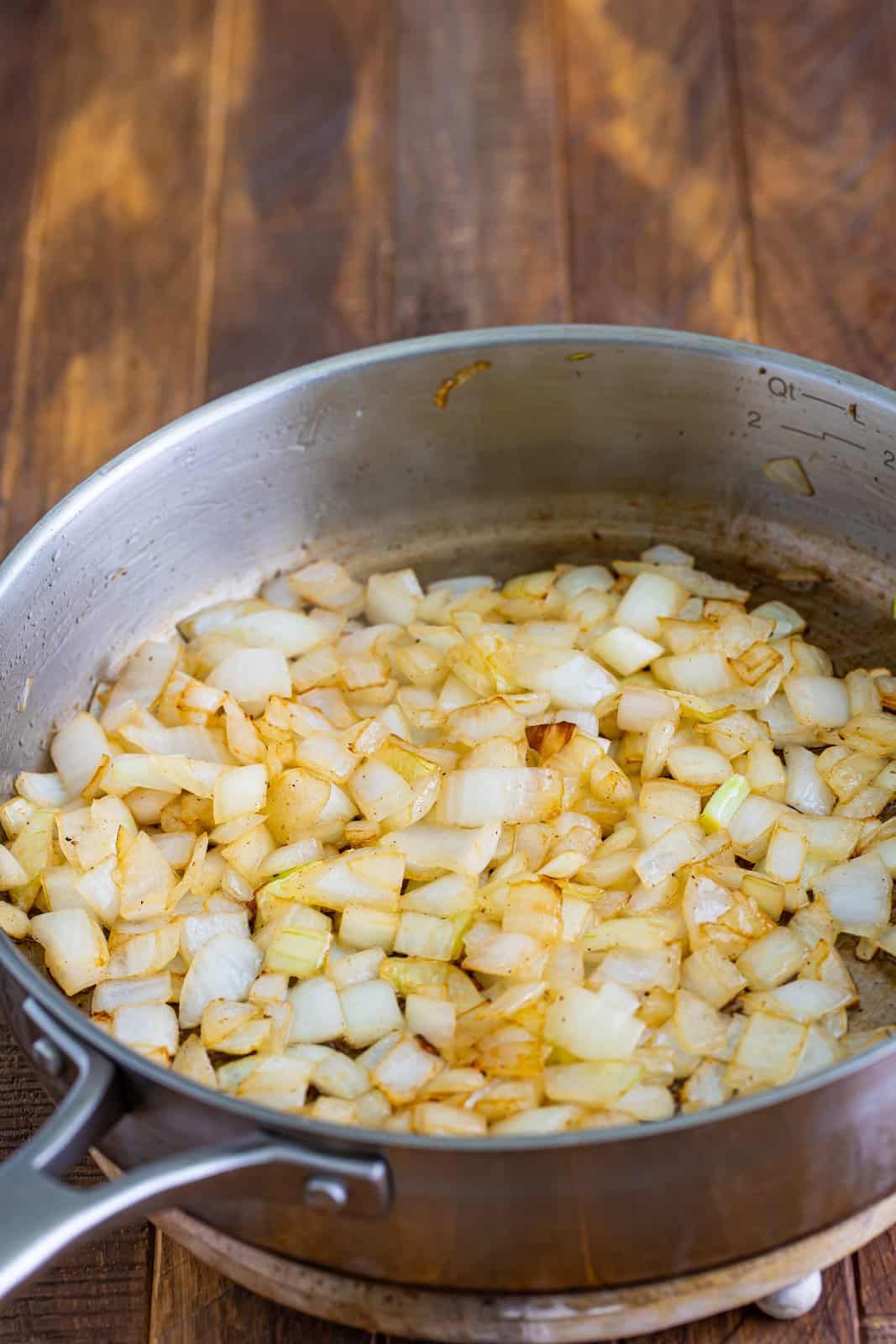 A saucepan of diced onion.
