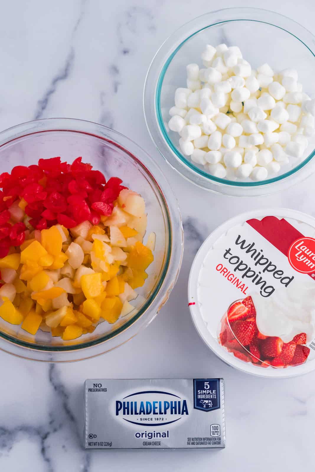 Cream cheese, whipped topping, marshmallows, canned fruit cocktail and cherries.