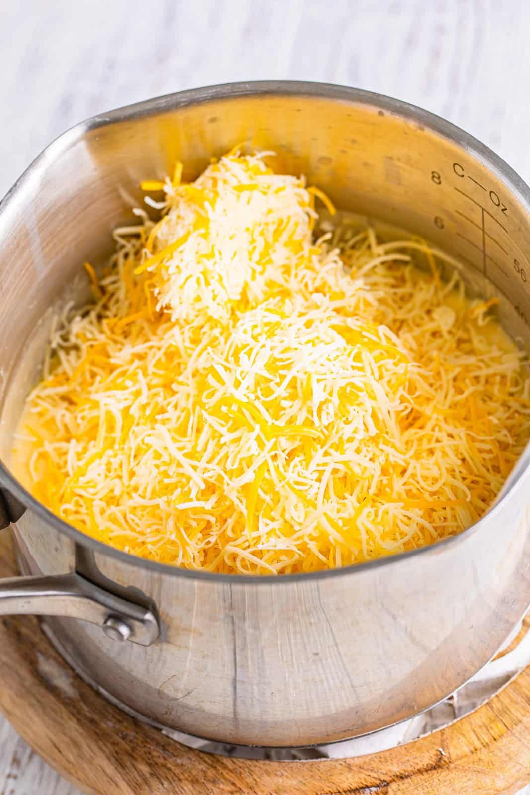 Shredded cheese in a saucepot.