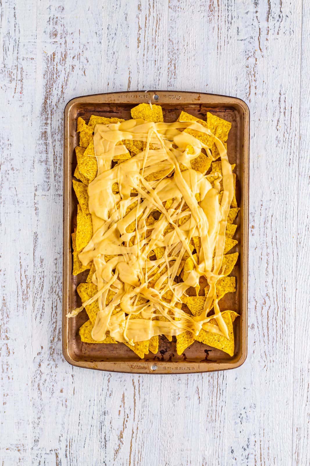 Tortilla chips with melted cheese sauce.