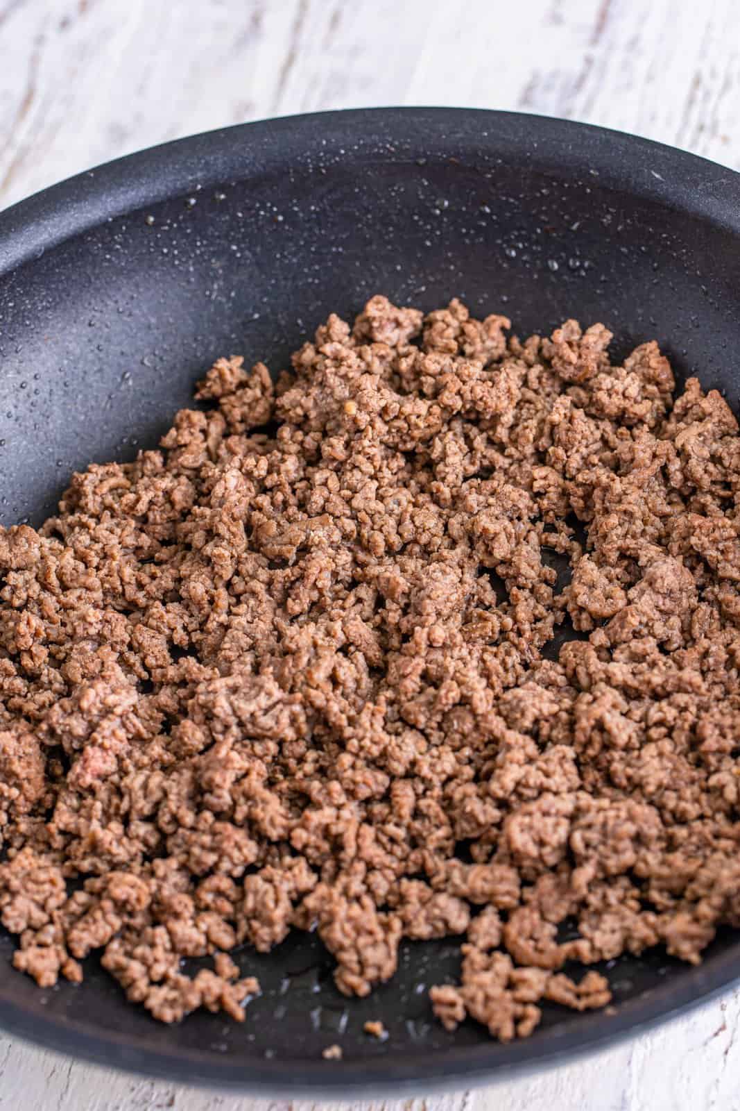 A skillet of cooked ground beef. 