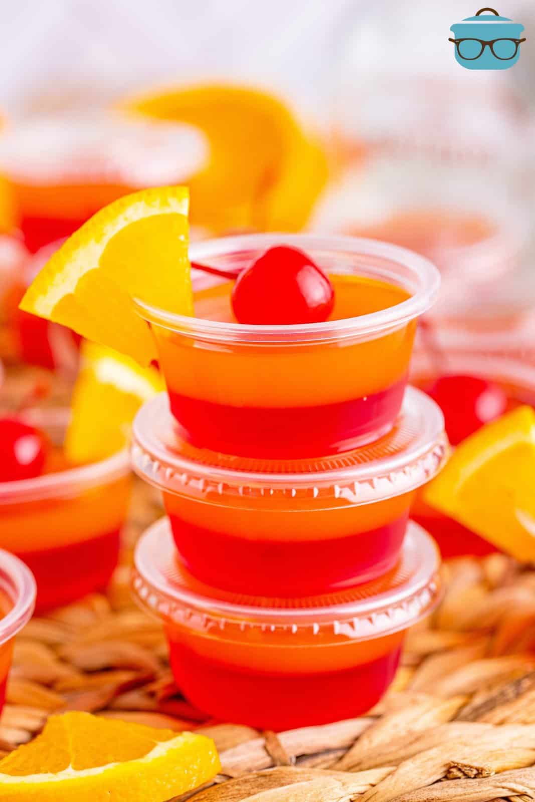 A triple stack of homemade Tequila Sunrise Jello Shots.