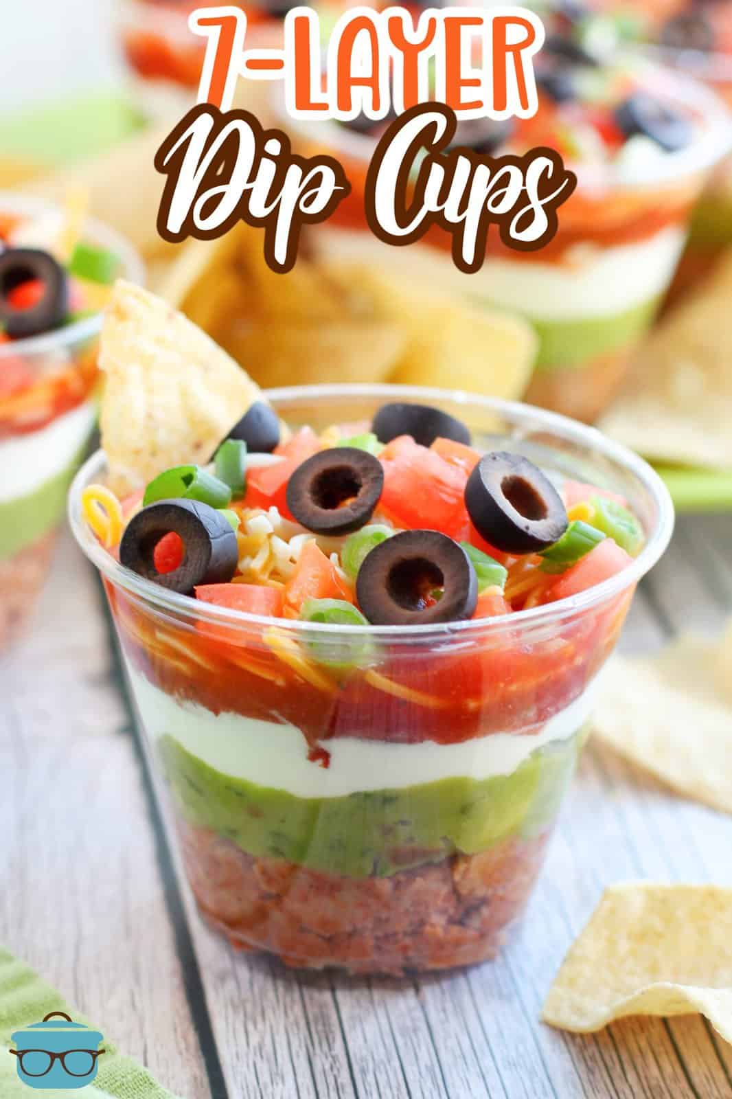 Close up looking at a layered cup with mexican dip.