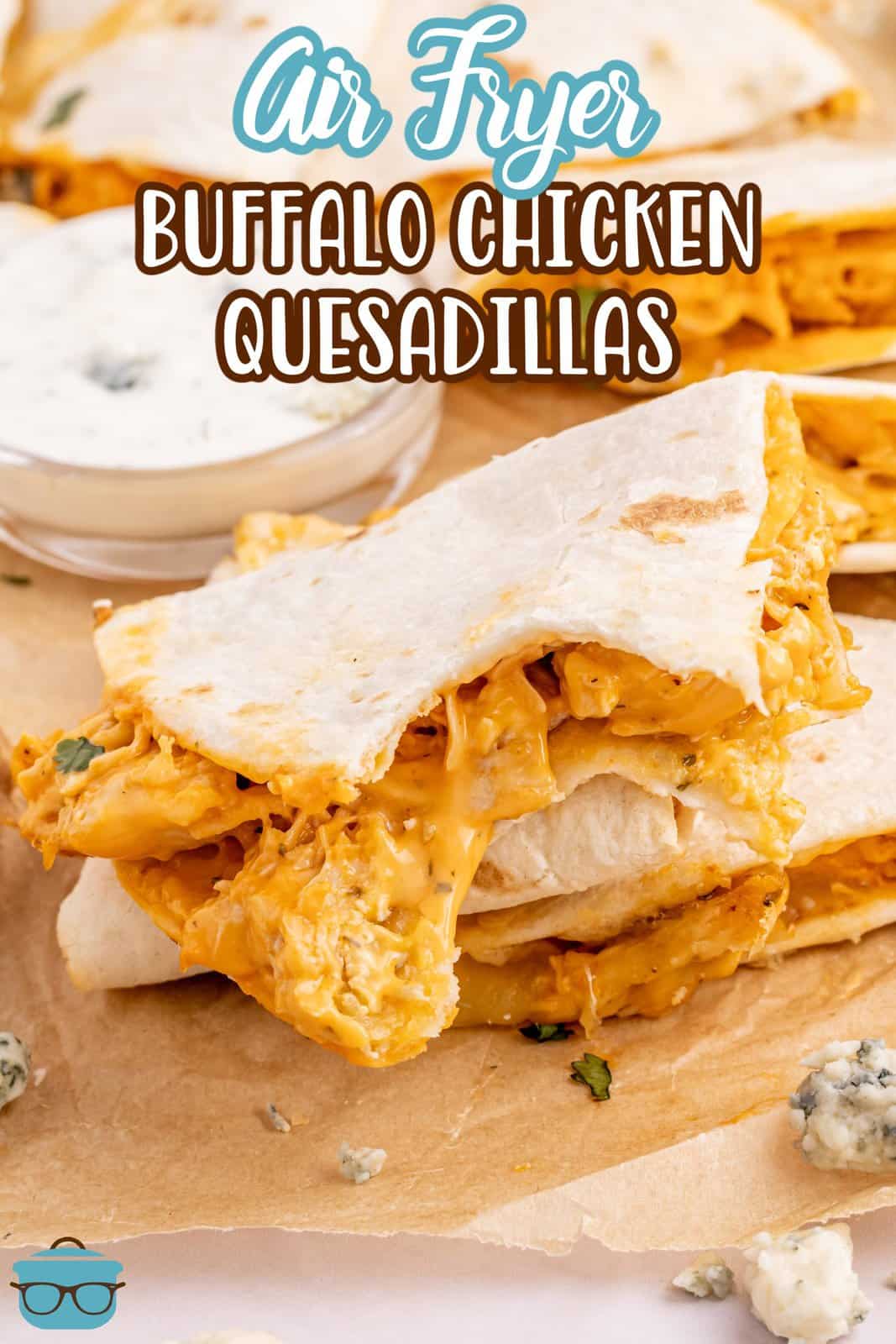 A few Buffalo Chicken Quesadillas with a bite taken out of one.