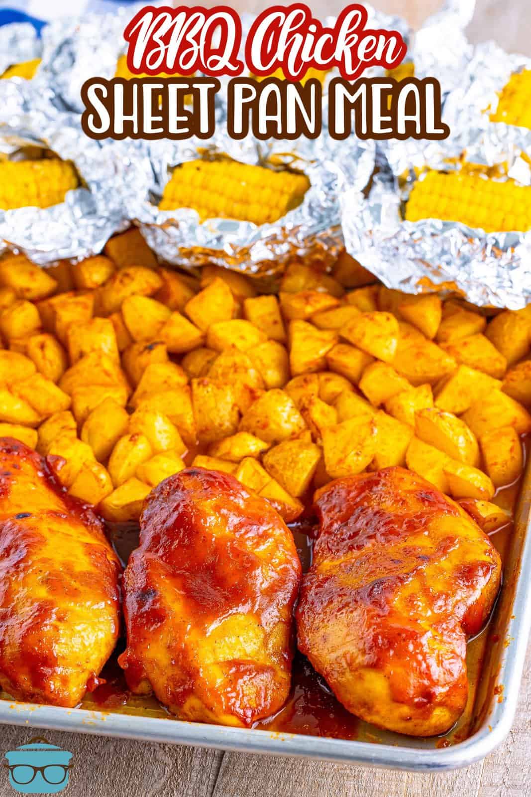 Corn on the cob in aluminum foil, a section of potatoes, and some BBQ chicken.