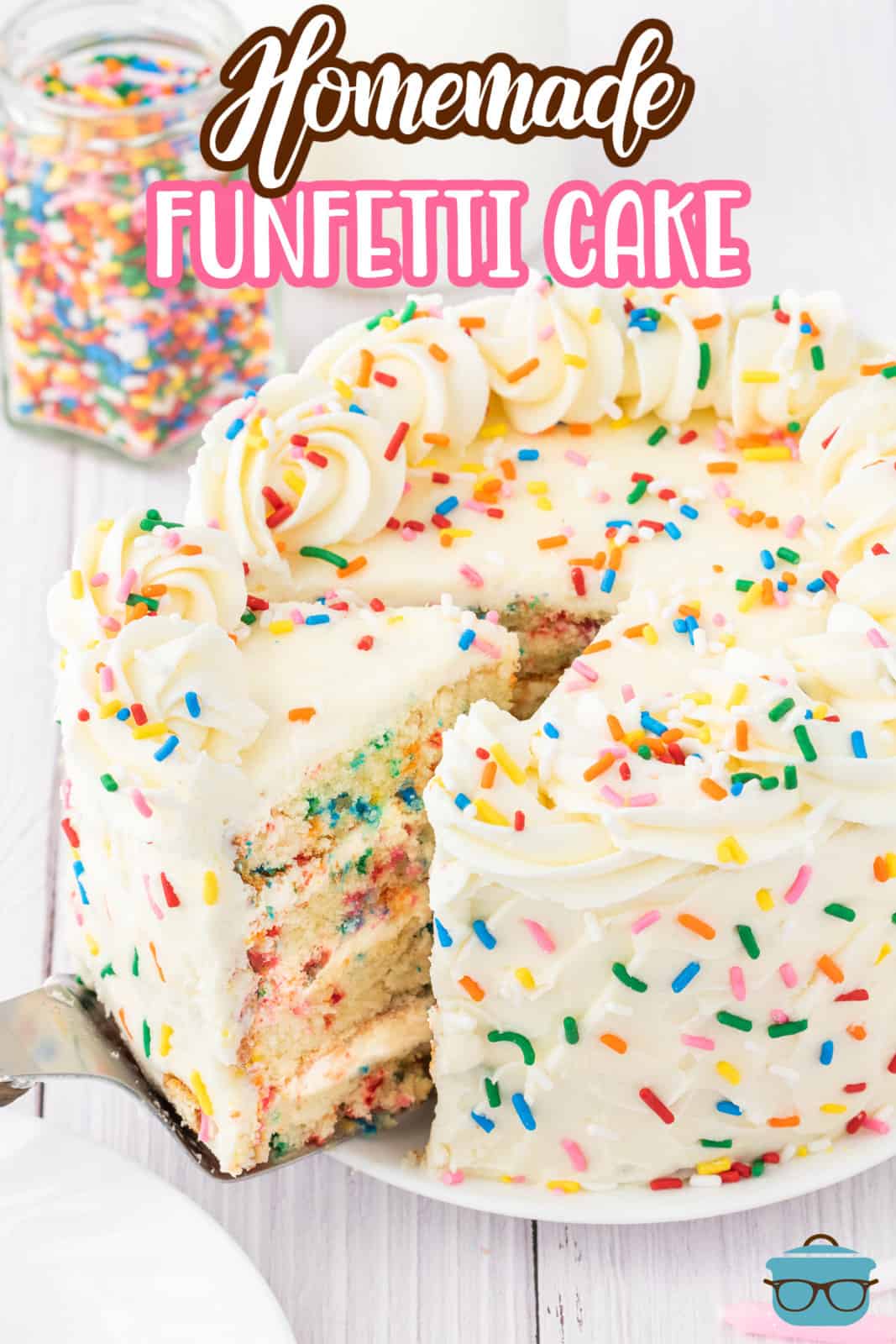 A Funfetti Layer Cake with a slice being removed on a cake plate. 