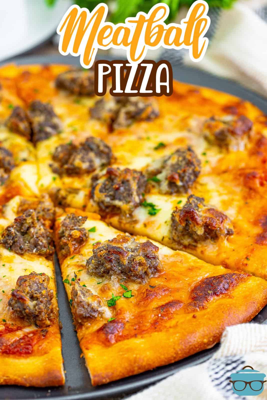 Close to a meatball pizza so you can see the meat and cheese. 