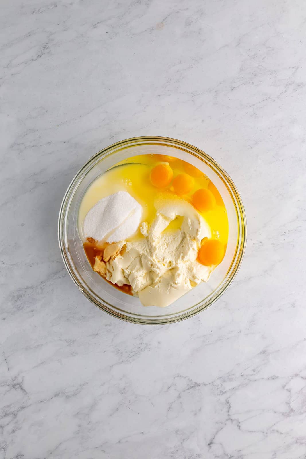 Ricotta, eggs, sugar, and vanilla in a large bowl.