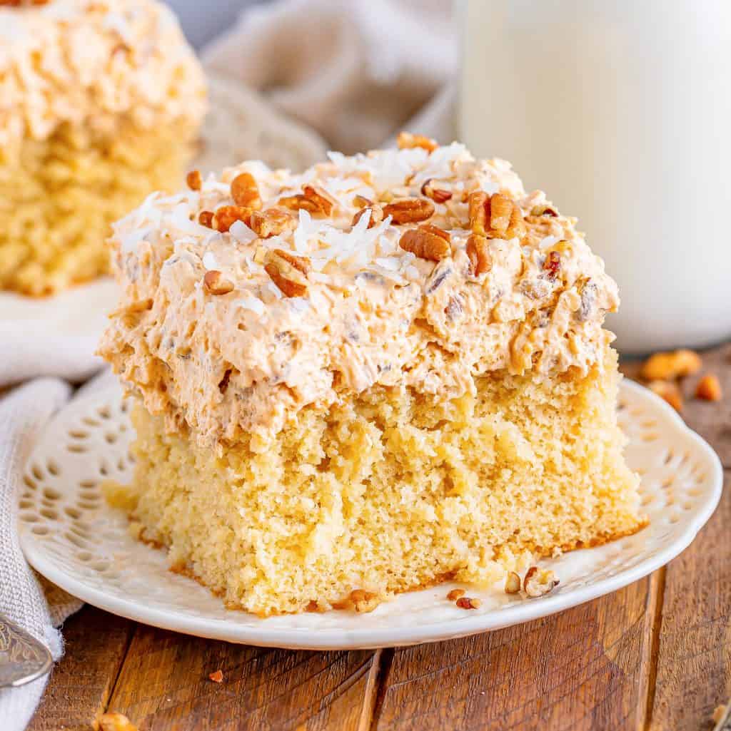 A cake with a slice of Butter Pecan Poke Cake.