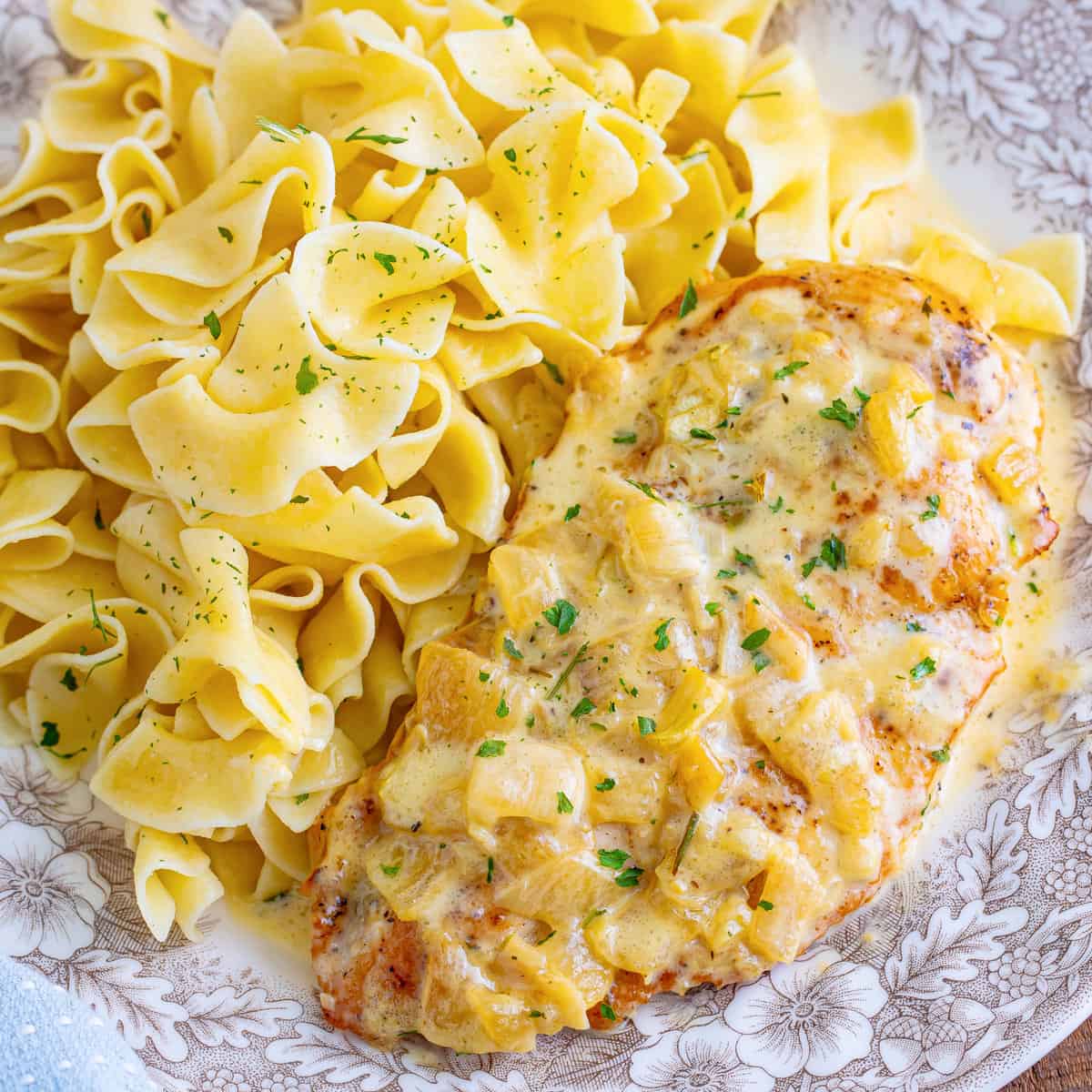 Looking down on a plate of Creamy Garlic Chicken with pasta.