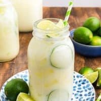 A jar of Brazilian Lemonade with fresh limes.