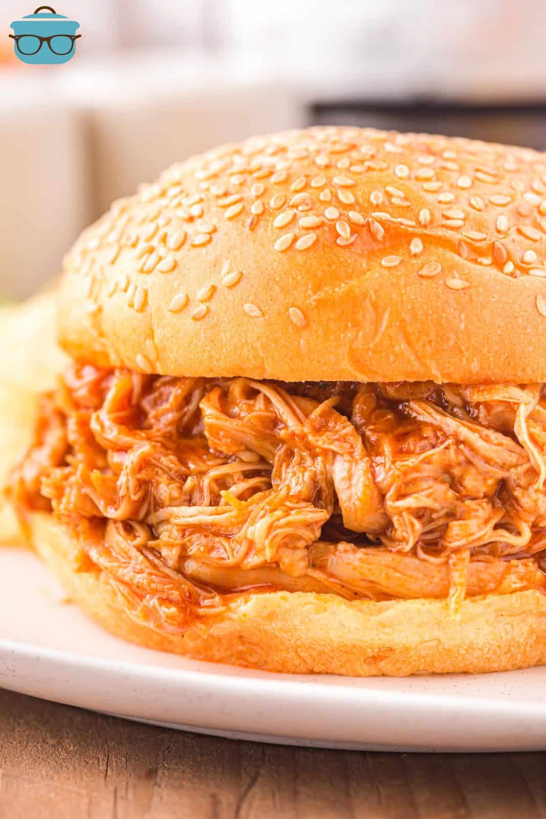 A delicious bbq chicken sandwich on a plate. 