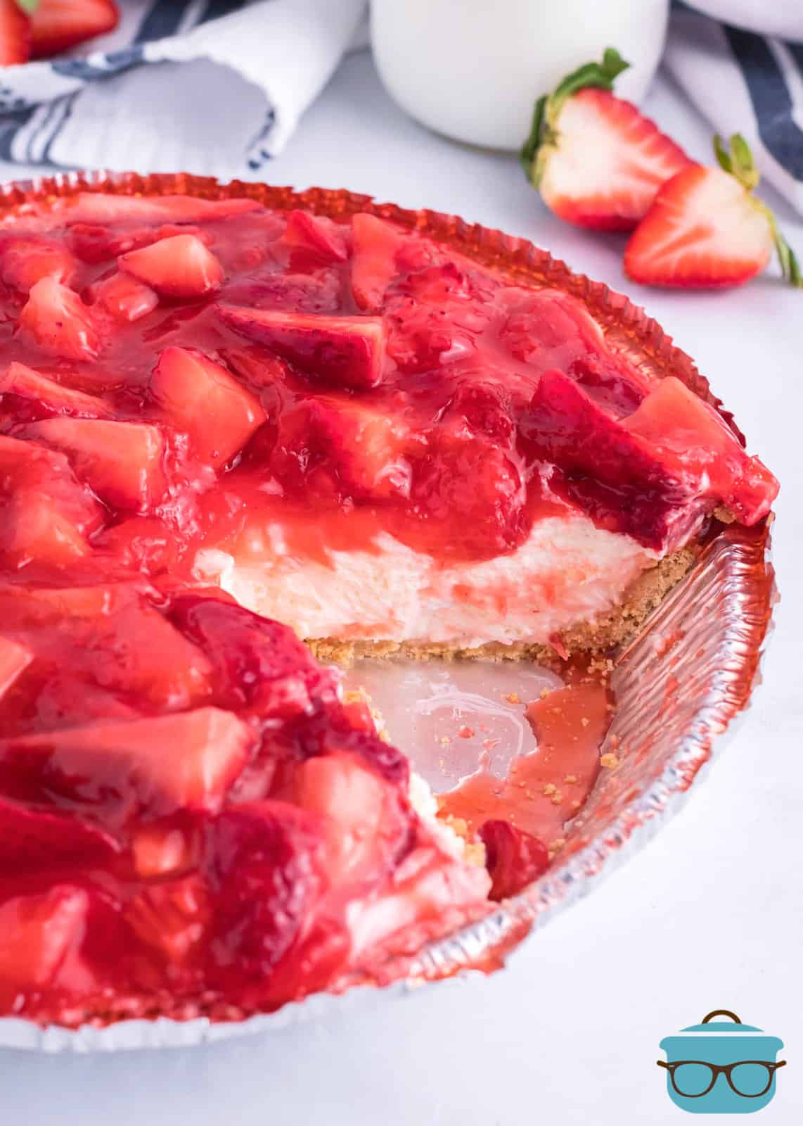 A whole Strawberry Cream Cheese Pie with a slice missing.