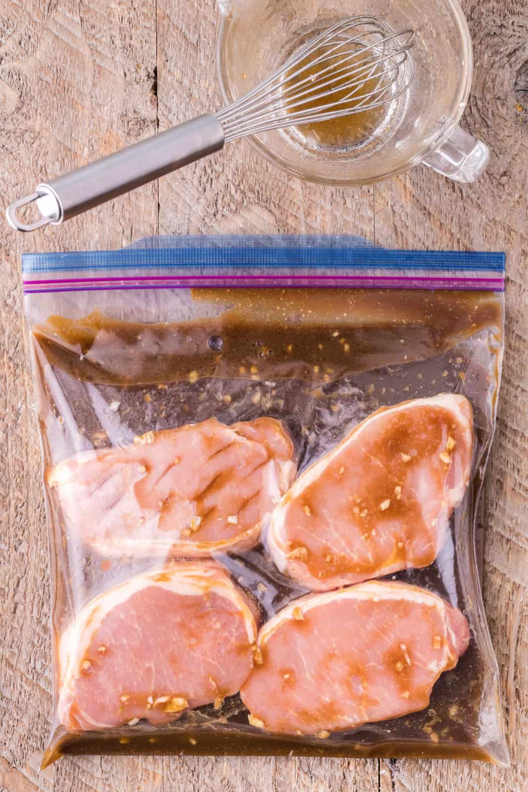 Pork chops in marinade in a bag.