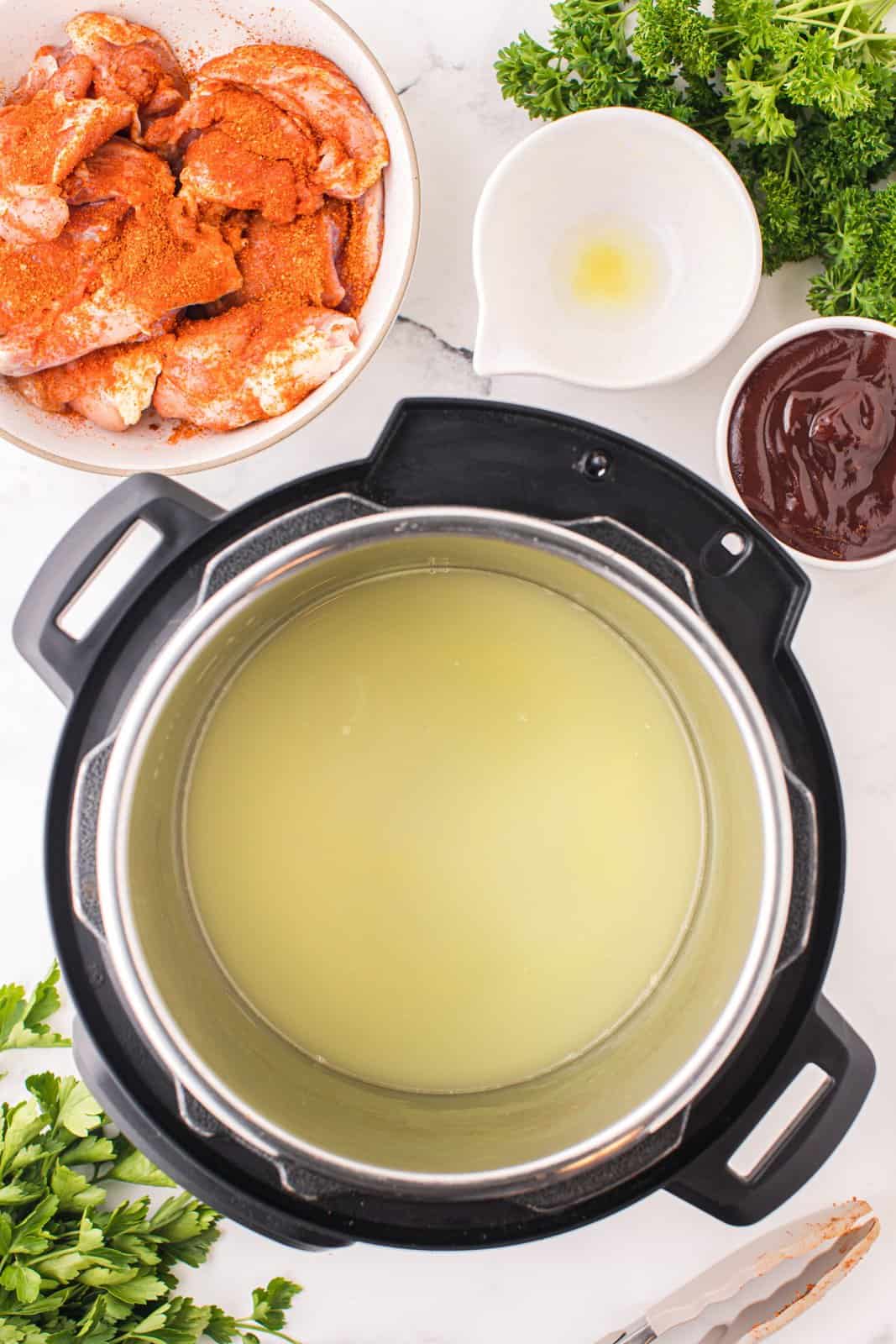 An instant pot with chicken stock.