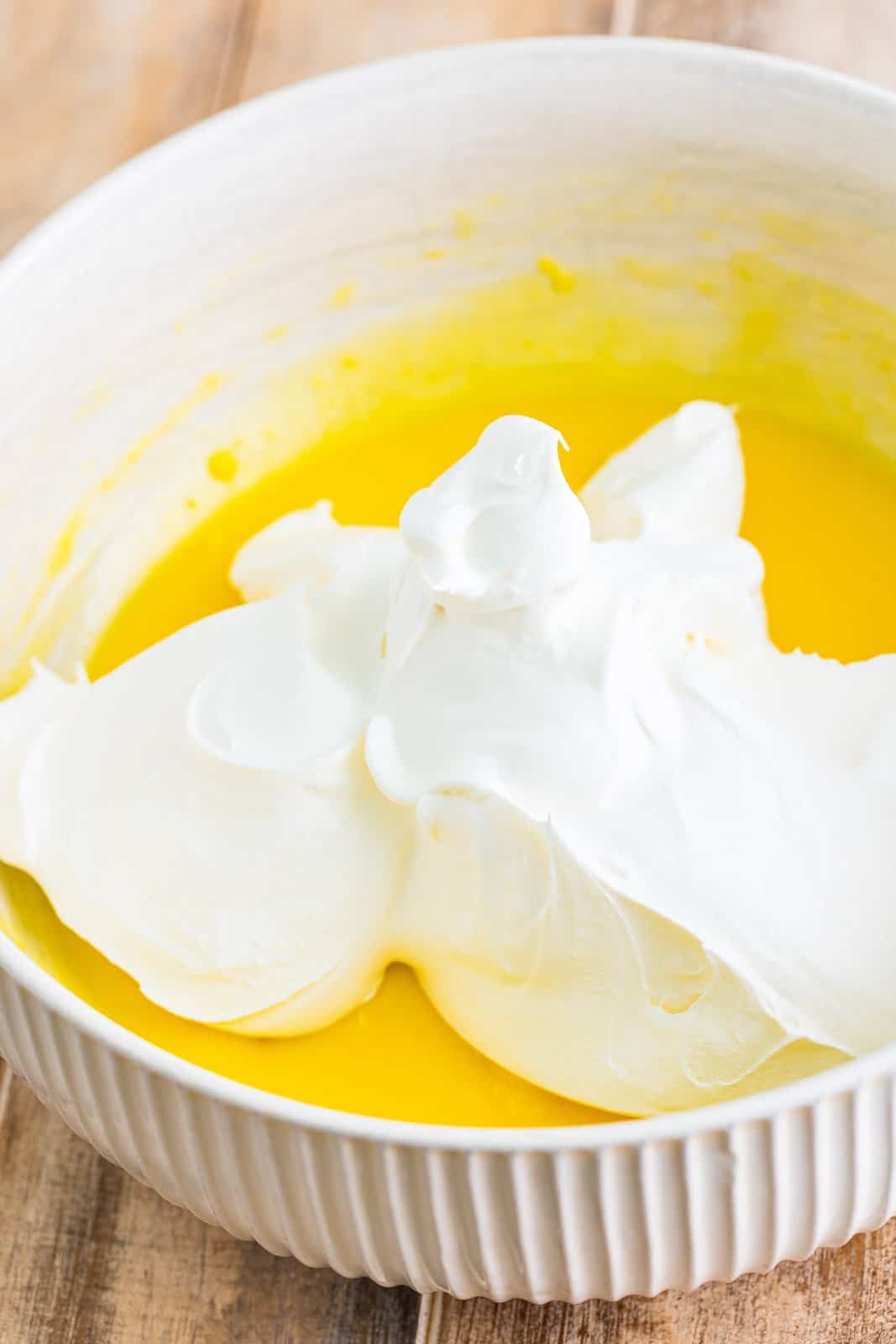 Whipped topping in a bowl of vanilla pudding.
