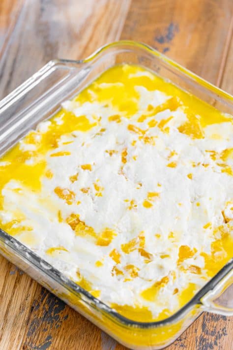 Melted butter with biscuit dough in a baking dish.
