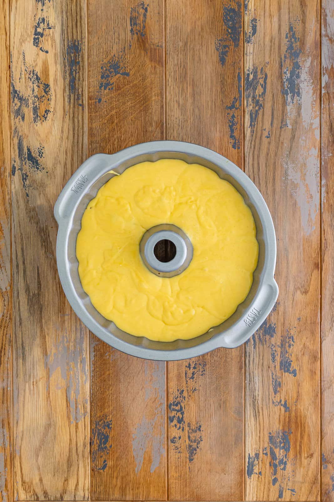 A bundt pan with the sock it to me cake batter and filling in it. 