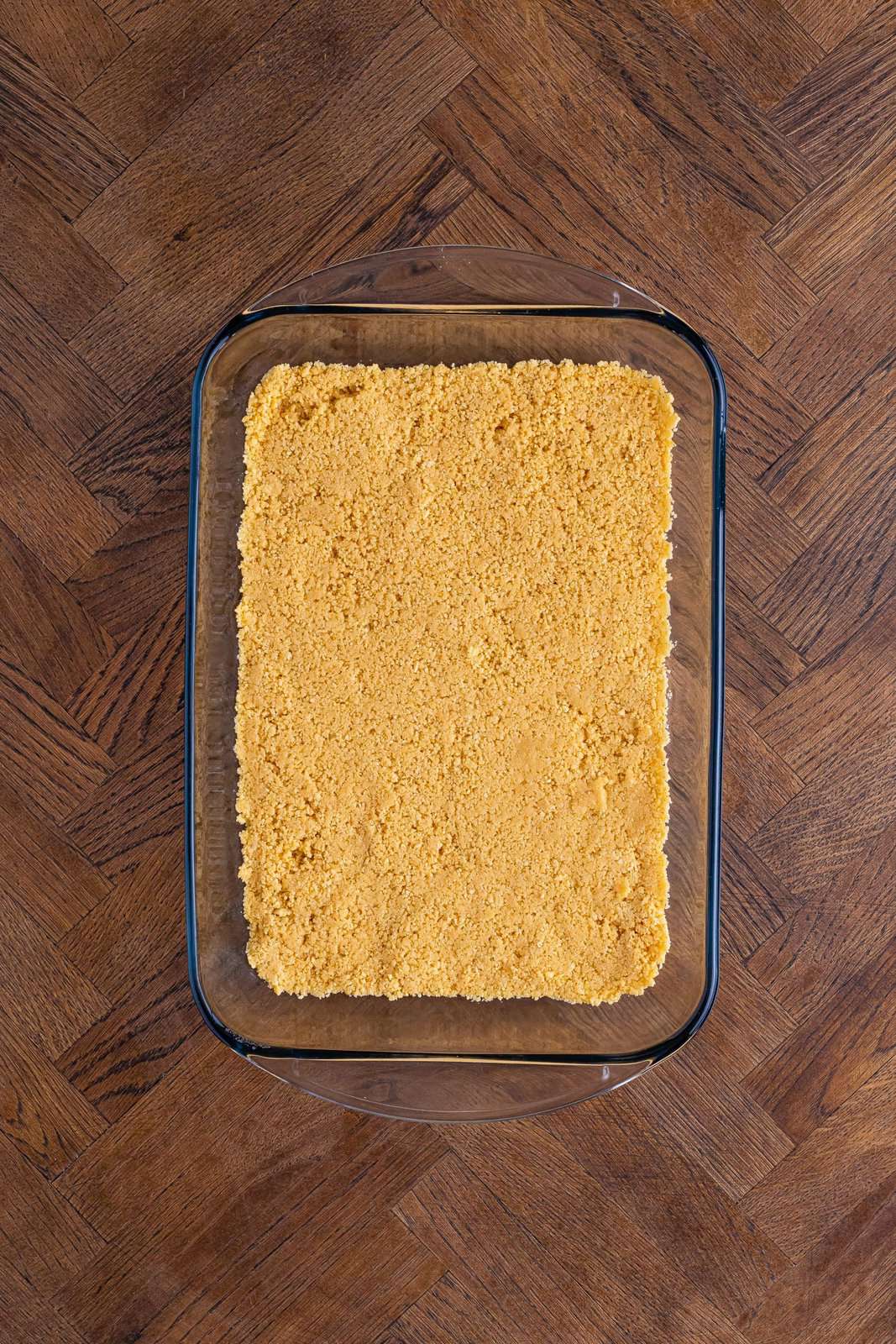 Golden Oreo crumb crust in a baking dish.