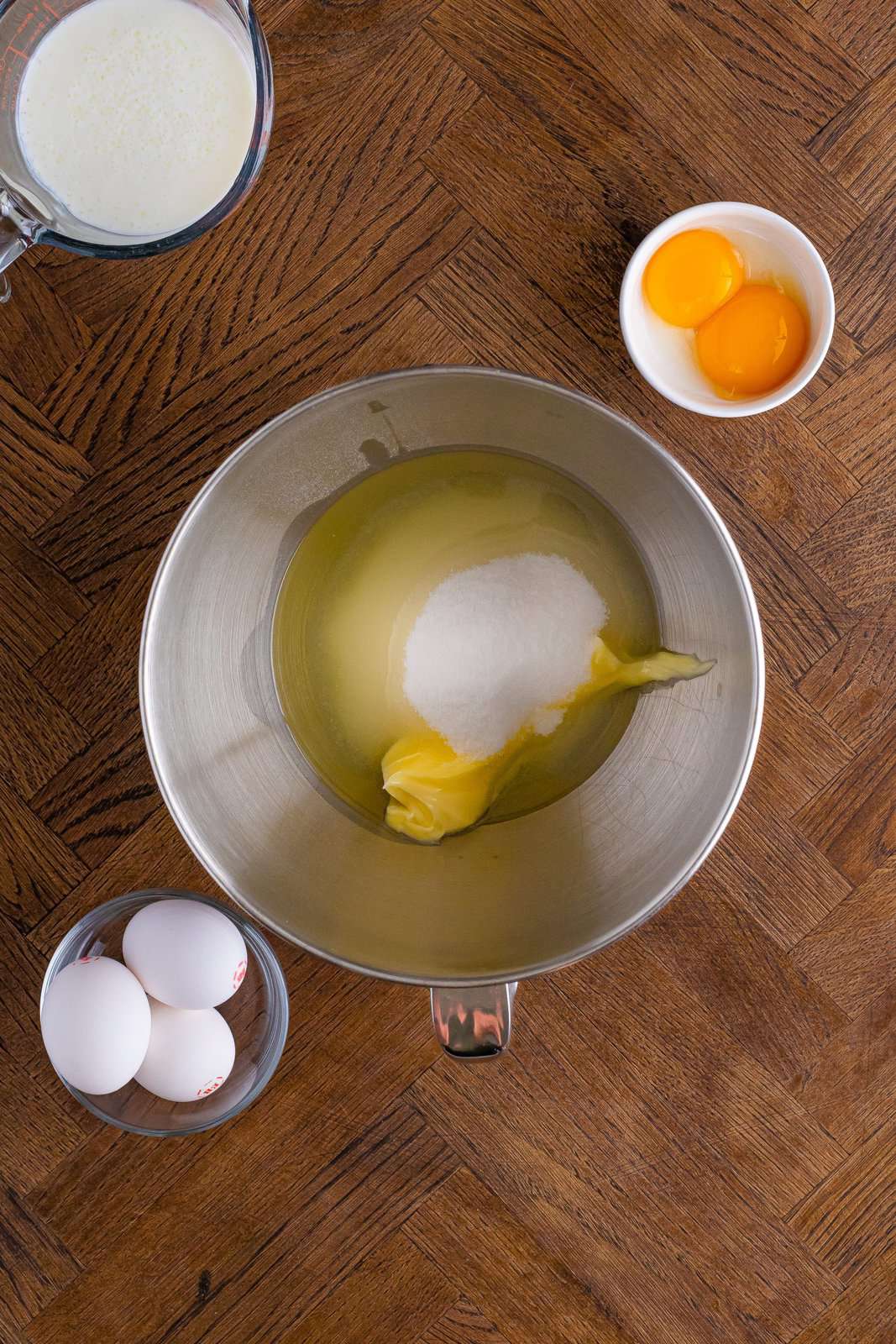 A mixing bowl with butter, oil, and sugar.