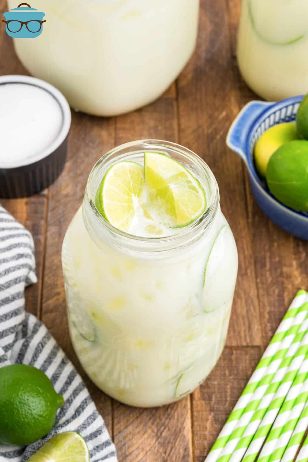 A glass of limonada, Brazilian Lemonade with fresh limes on top.
