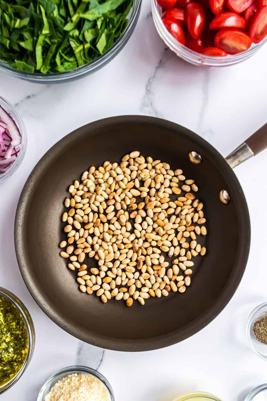 Pine nuts in the skillet. 