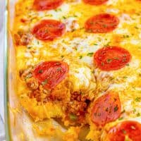 A close up looking at some puffy pizza casserole with some out of the dish.