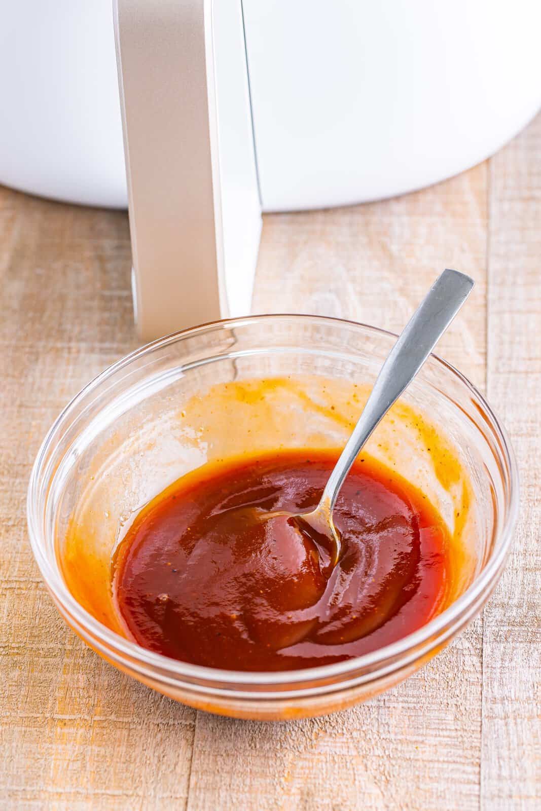 BBQ sauce and water in a mixing bowl.