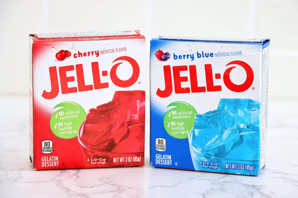 A box of cherry Jell-O and a box of Berry Blue Jell-O.