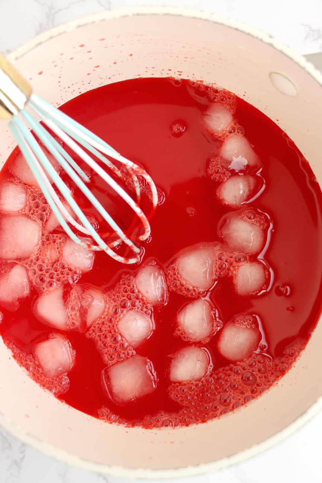 Ice cubes in a cherry jello mixture. 