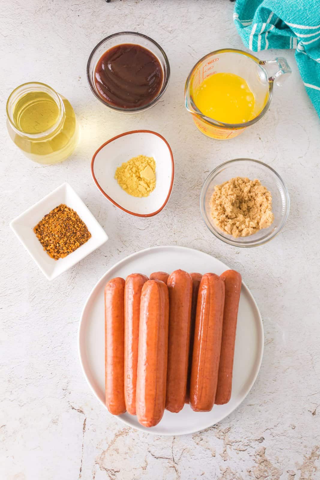 Hot dogs, dry mustard, olive oil, BBQ seasoning, BBQ sauce, butter, and brown sugar. 