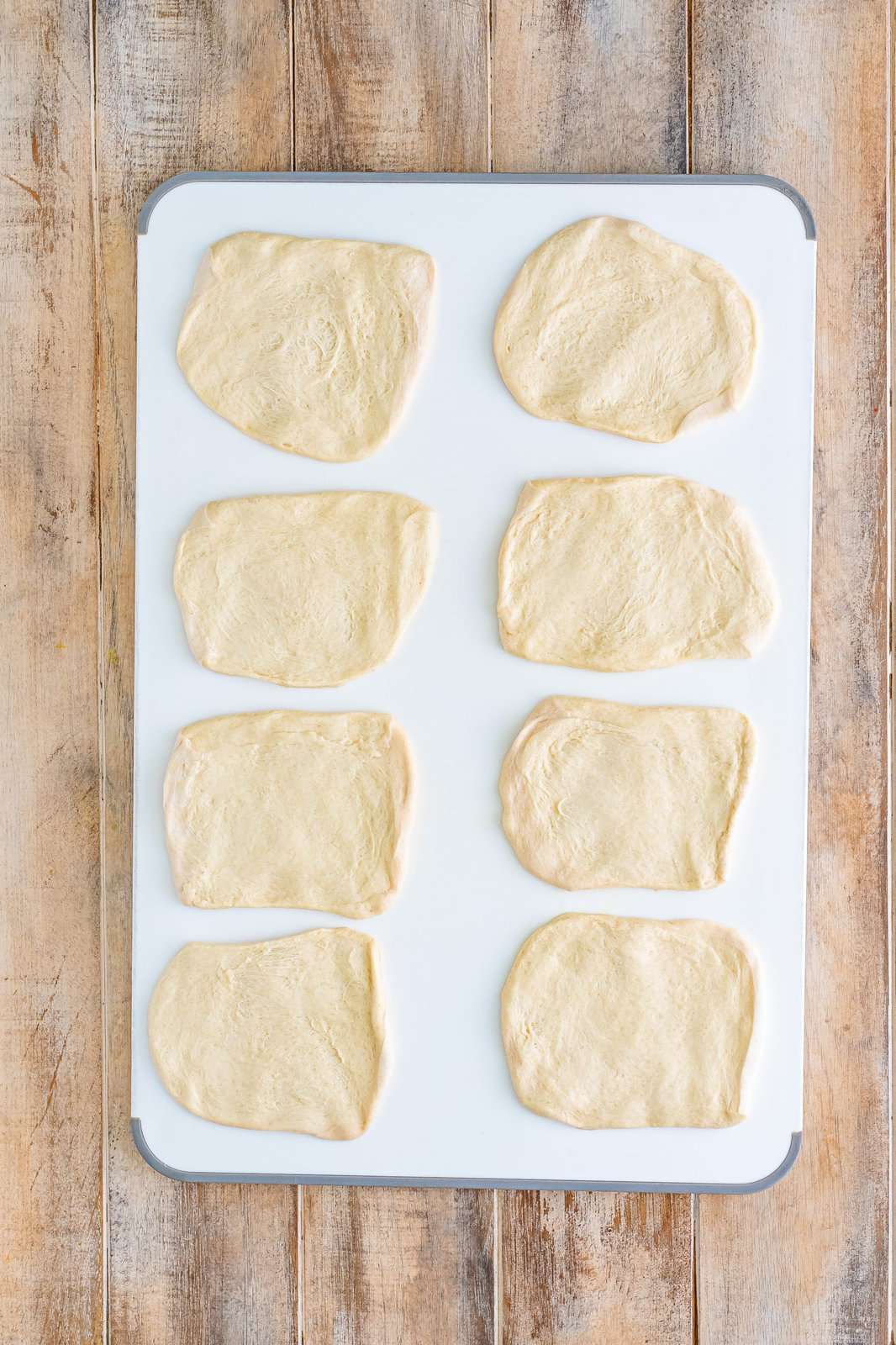 Flattened bread dough in 8 pieces.