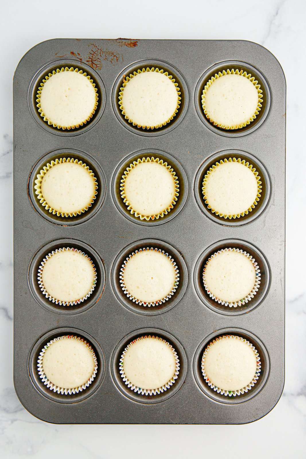 Baked cupcakes in a cupcake tin.