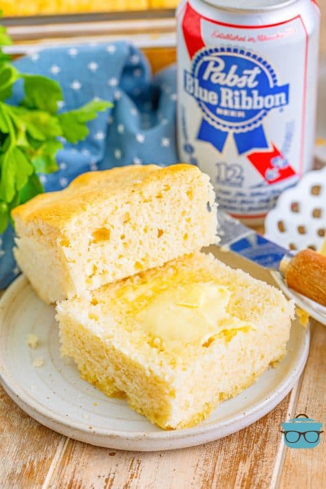 Two slices of Beer Bread Butter Swim Biscuits on a plate.