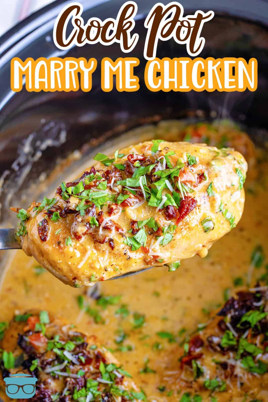 A piece of Marry Me Chicken on a serving utensil over a Crock Pot.