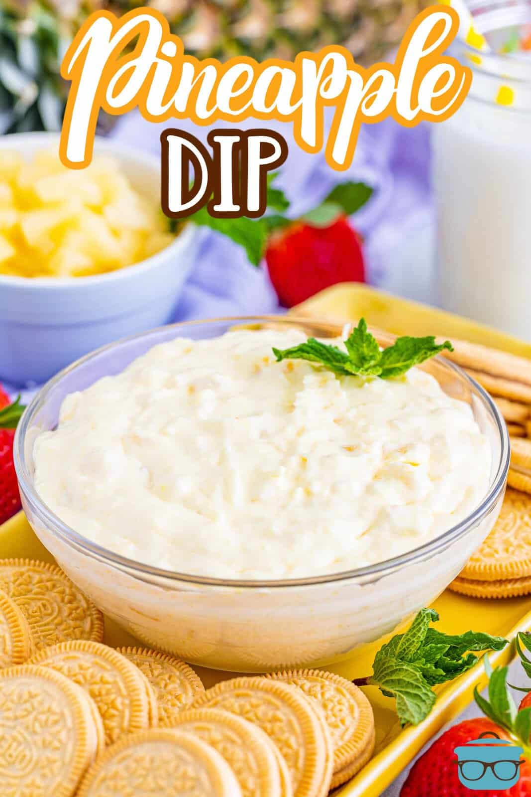 A small bowl of pineapple dip with cookies in front.