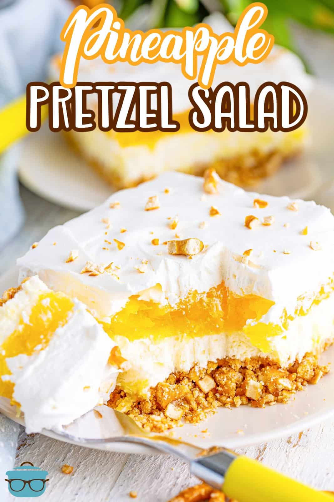 A square of Pineapple Pretzel Salad with a bite missing.