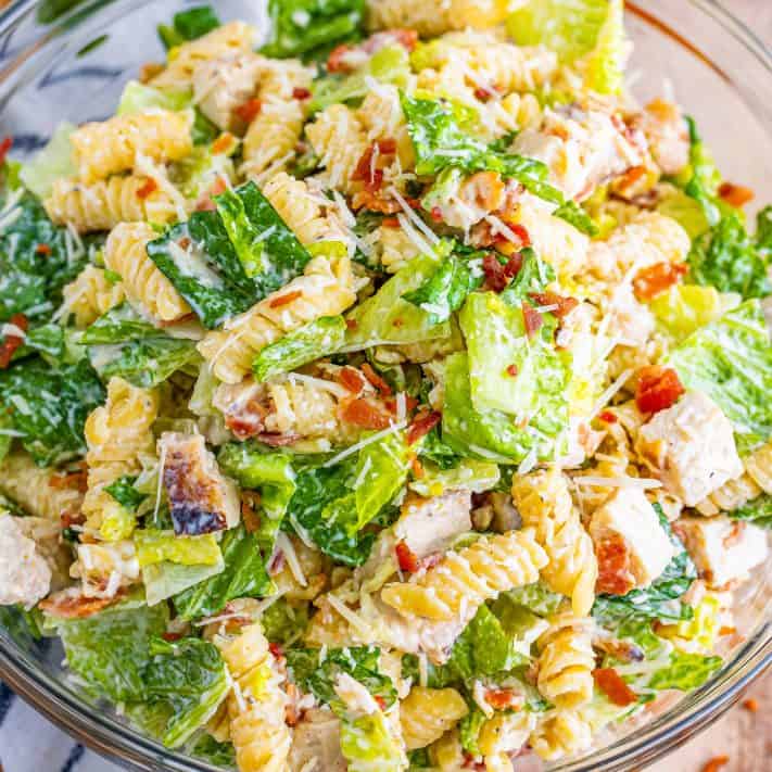 Looking down on a bowl of chicken Caesar pasta salad.