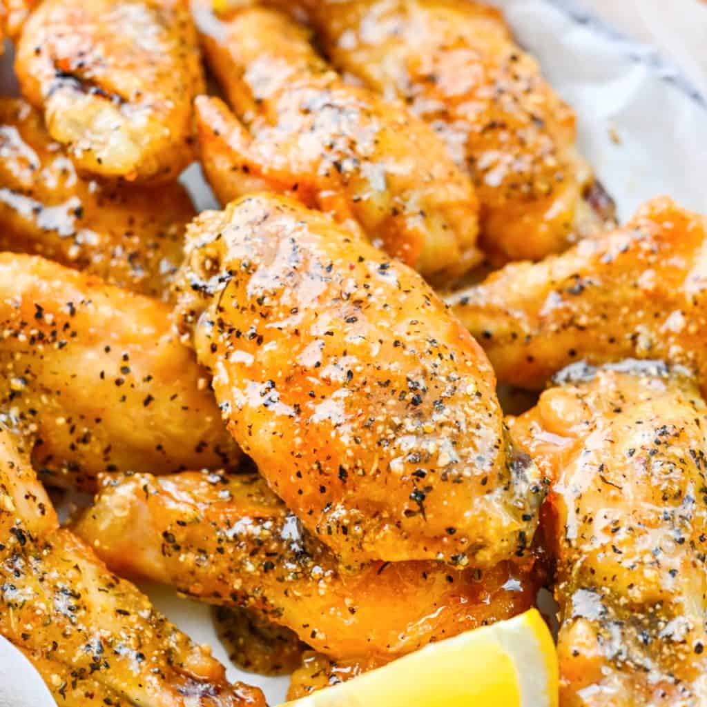 Close up looking at a bunch of lemon pepper baked chicken wings.