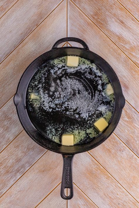 Butter and bacon grease in a cast iron skillet.