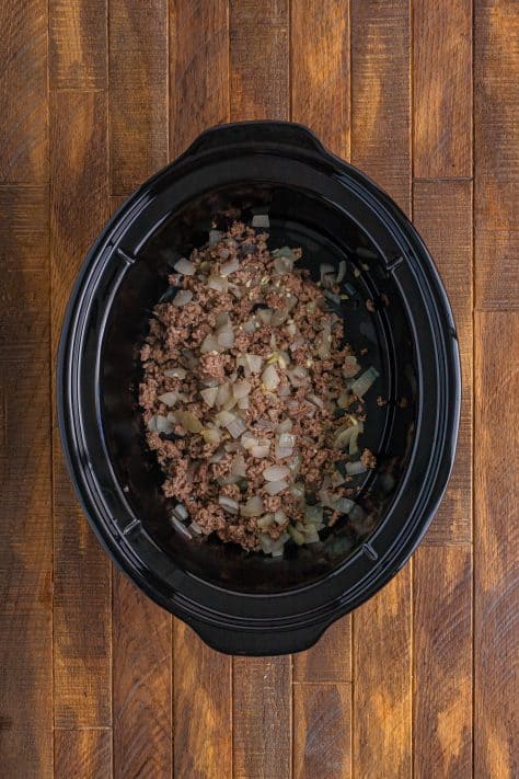 Ground beef, onion, and garlic in a Slow Cooker.